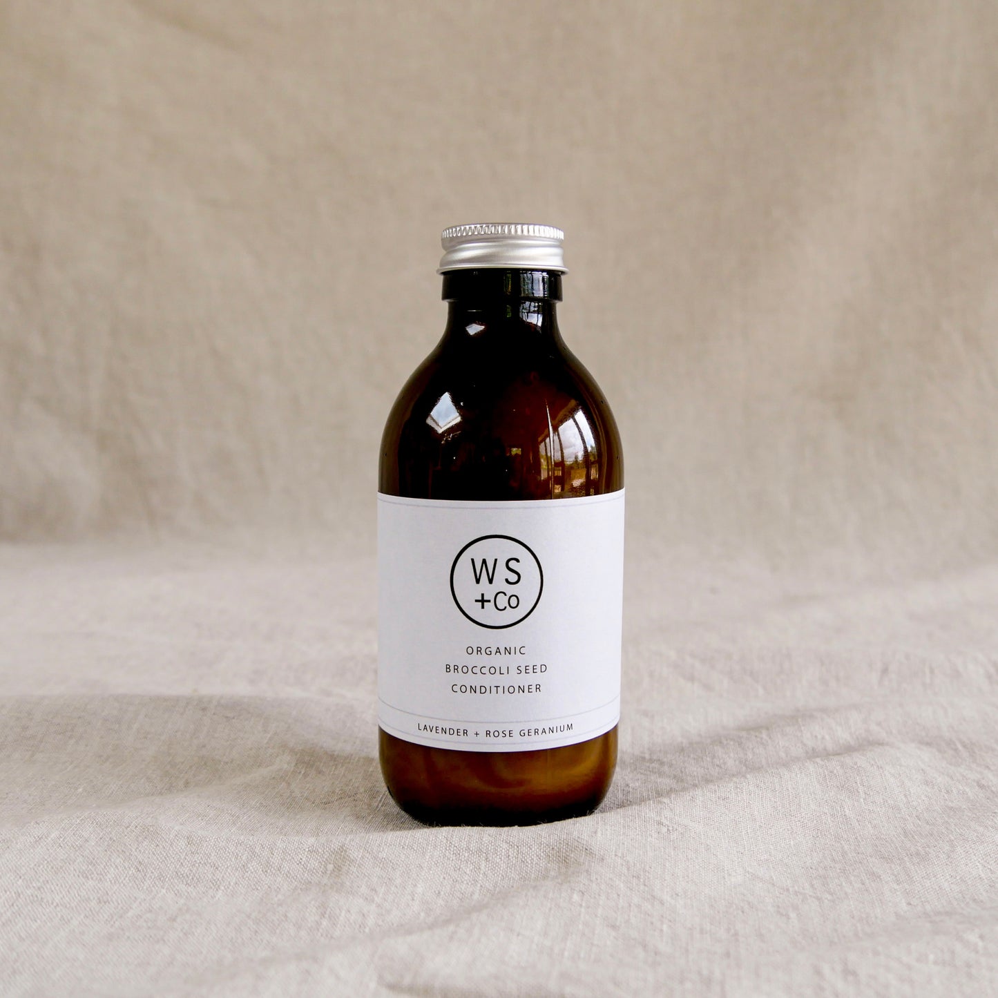 Bottle of WS+Co organic broccoli seed conditioner with screw top