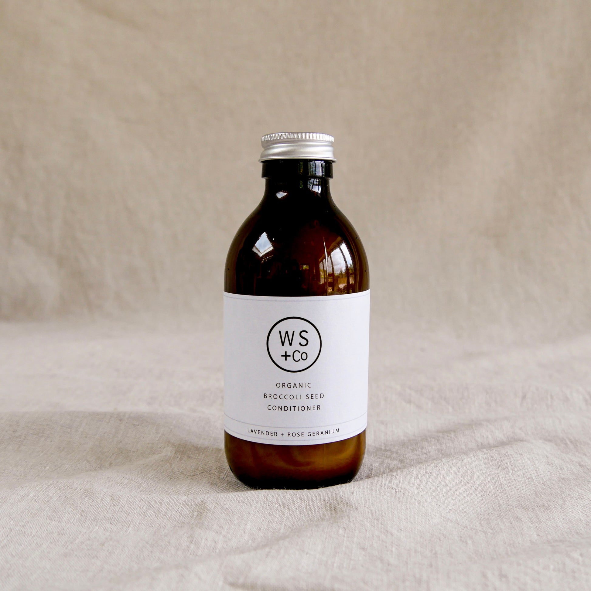 Bottle of WS+Co organic broccoli seed conditioner with screw top