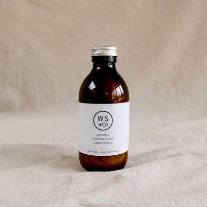 Bottle of WS+Co organic broccoli seed conditioner with screw top