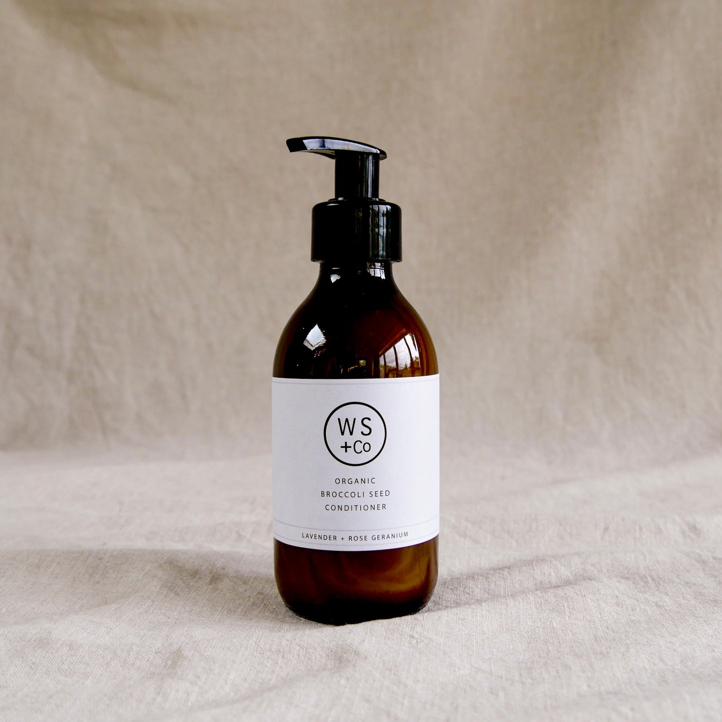 Bottle of WS+Co organic broccoli seed conditioner with pump