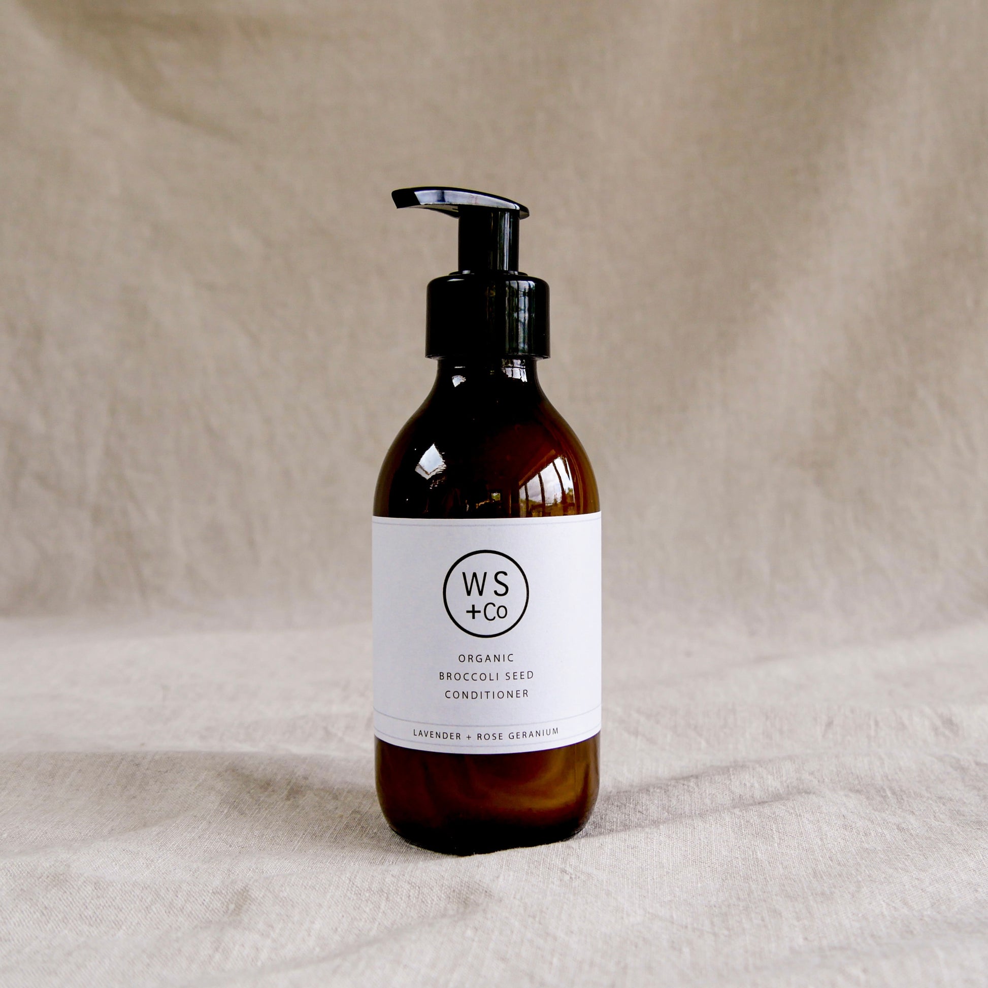 Bottle of WS+Co organic broccoli seed conditioner with pump