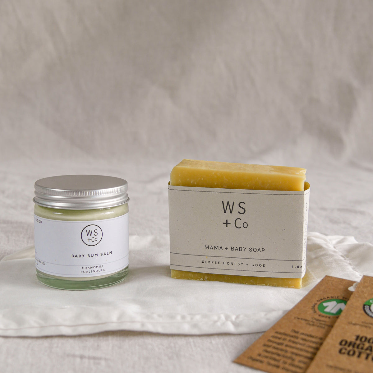 WS + Co baby products including a jar and soap bar on a neutral background
