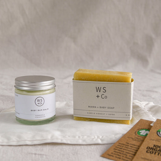 WS + Co baby products including a jar and soap bar on a neutral background